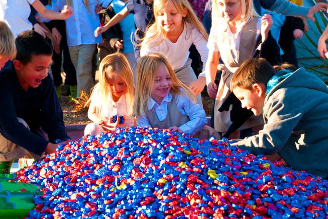Students at DJ's Christian Academy rush to fill their pockets from a 15,000-plus pile of Dove chocolates, Wednesday Dec. 14, 2011. In12Days, a charity organization, surprised the students with a very special chocolate delivery.
